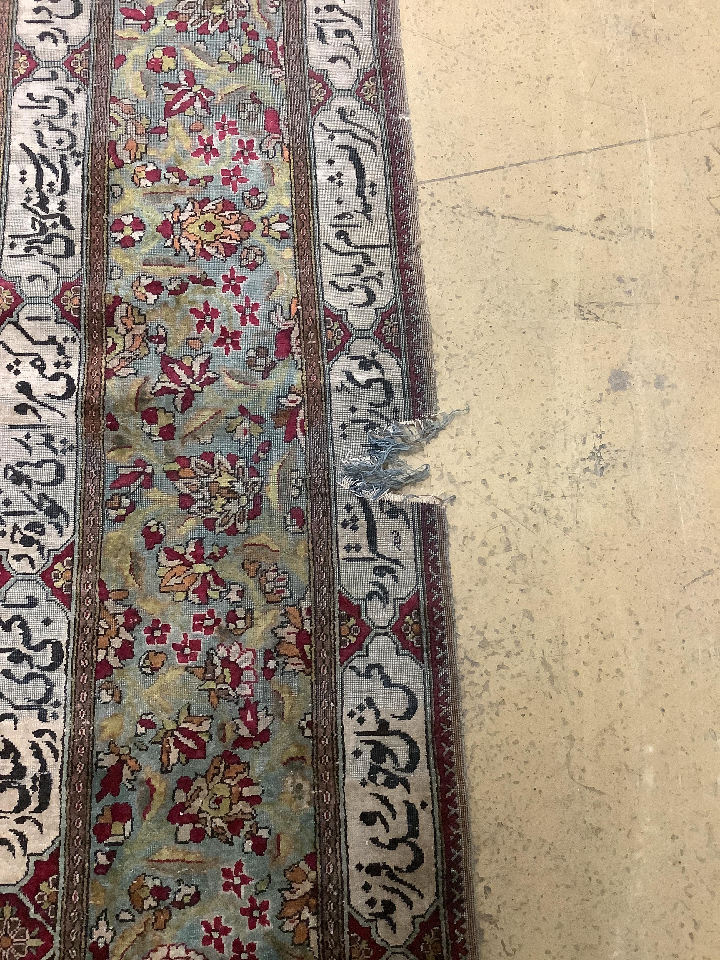 An antique Tabriz part silk rug, holed and worn, 198 x 136cm